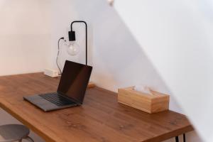 a laptop computer sitting on a wooden table with a box at いなぎの木箱 in Zentsuji