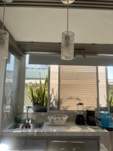 a kitchen counter with a sink and a window at Apartamento Centro Histórico Cartagena in Cartagena de Indias