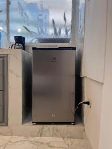 a refrigerator in a kitchen next to a window at Apartamento Centro Histórico Cartagena in Cartagena de Indias