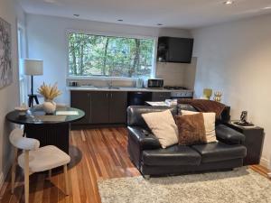 a living room with a couch and a table at Lochiel Cottages - Dandenong Ranges Escape in Olinda