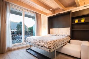 a bedroom with a bed and a large window at Lake Home Holiday in Como