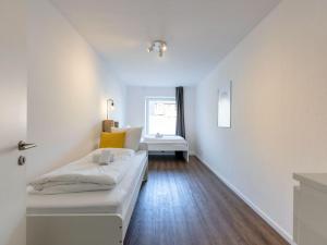 a living room with a white couch and a window at BudgetRoom 3 BR perfect for Teams in Castrop-Rauxel +5 photos