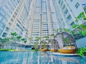 a group of bird cages in front of a tall building at JiL JiL homestay in Trạm Chánh An
