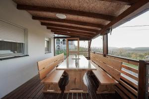 a table on the balcony of a house at Hill House Vrcelinija in Vuglovec