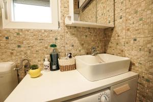 a white sink in a small kitchen with a window at Hill House Vrcelinija in Vuglovec