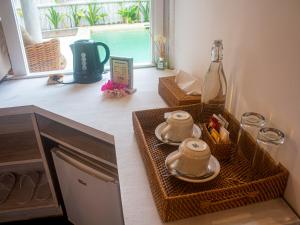 a kitchen counter with two baskets and a window at Ora Resort Gili Meno in Gili Meno
