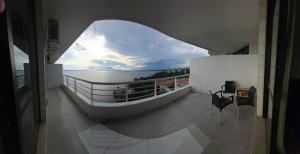 a room with a balcony with a view of the water at Suíte com varanda Tropical Hotel in Manaus +3 photos