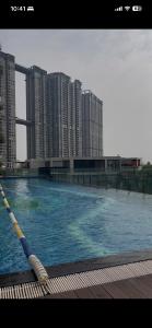 a large swimming pool in front of tall buildings at Canary Nest Solforest Ecopark Homestay in Kim Quan