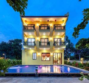 a house with a swimming pool in front of it at Le Maison Tam Coc Boutique Hotel in Ninh Binh
