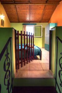a room with a bed in a room with a fence at Haroula Apartments in Sidari
