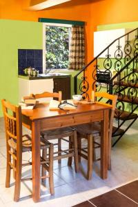 a dining room with a wooden table and chairs at Haroula Apartments in Sidari