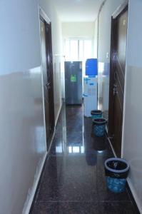 a hallway with three toilets in a room at Prime PG - Coliving Hostel in Hyderabad