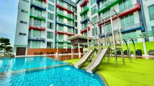 a swimming pool with a slide in front of a building at V8 Hotel Johor Bahru in Johor Bahru