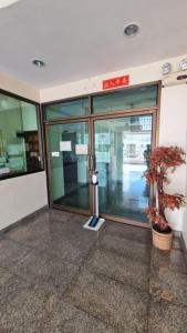 an entrance to a building with a tree in front at My place 77 2 in Ban Khlong Khwang Klang