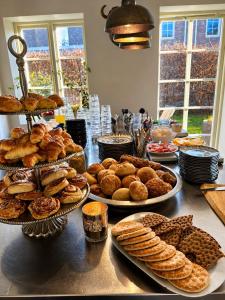 a table topped with plates of pastries and pies at Brohuspark in Lomma