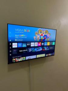 a flat screen tv hanging on a wall at My place 77 2 in Ban Khlong Khwang Klang
