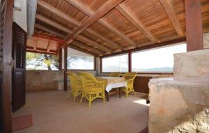 a dining room with yellow chairs and a table at House by the sea in Mali Iž