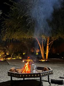 a fire pit with a pot on top of it at Mykonos Resort in Abu Dhabi