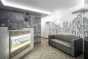 a living room with a couch and a wall mural at Hotel Sacvoyage in Lviv