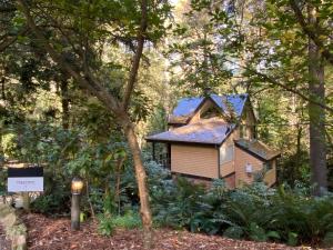 a small house in the middle of a forest at Lochiel Cottages - Dandenong Ranges Escape in Olinda