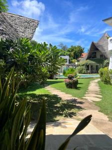 a garden of a house with a pathway at Fasha House Malindi in Malindi