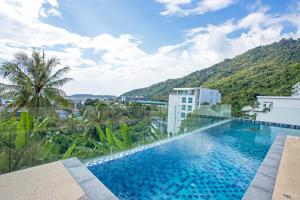 a swimming pool with a view of a mountain at Kata Hills Condo with Terrace & Sea View O910 in Ka Rorn