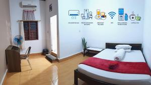 a bedroom with a bed with a red blanket at Labore Homestay in Waha