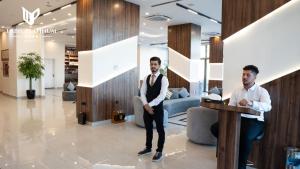 two men standing at a podium in a lobby at Erbil Platinum Hotel in Erbil +84 photos