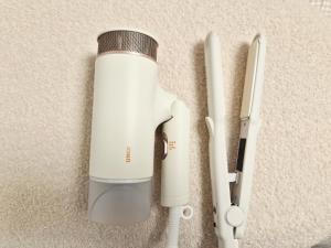 a white bottle is next to a white corded appliance at Coco Villa Sinsa in Seoul