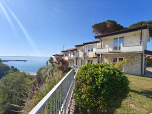 a house on a hill with the ocean in the background at OndaMaris Tropea in Tropea