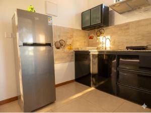 a large stainless steel refrigerator in a kitchen at La Nuit Étoilée , Restez plus, payez moins ! in La Gaulette
