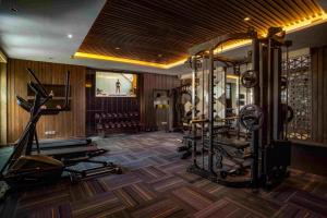 a gym with several tread machines in a room at The Vira Bali Boutique Hotel & Suite in Kuta