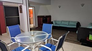 a glass table and chairs in a living room at Fortaleza Diosa Chia in Chía +12 photos