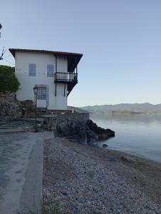 a building on the shore of a body of water at Konstantinos in Chorto