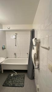 a bathroom with a bath tub and a sink and a shower at kenneth's Home in Stockholm