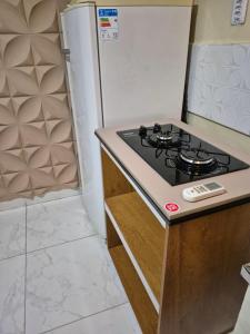 a kitchen with a stove and a refrigerator at Rosy flat térreo in Petrolina