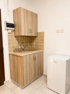a kitchen with a sink and a refrigerator at Peyia traditional house in Paphos +7 photos