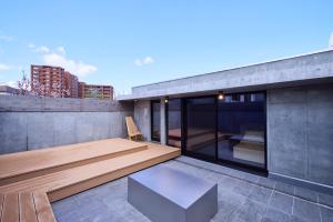 a balcony with a bench and a table on a building at 開土 KAIDO Hotel in Sapporo
