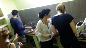a group of people standing in a kitchen at pondicherry hostel in Pondicherry