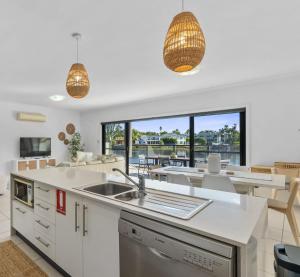 a kitchen and living room with a view of the ocean at The Lake House in Mulwala