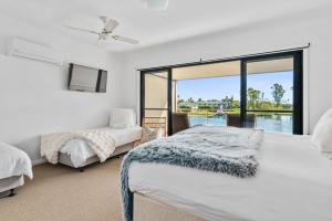 a bedroom with two beds and a view of the water at The Lake House in Mulwala