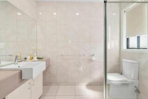 a bathroom with a shower and a toilet and a sink at The Lake House in Mulwala +13 photos