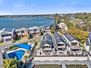 an aerial view of a house with the water at The Lake House in Mulwala