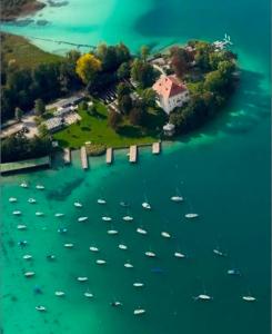 an island with a bunch of boats in the water at Klagenfurt Apartment in Klagenfurt