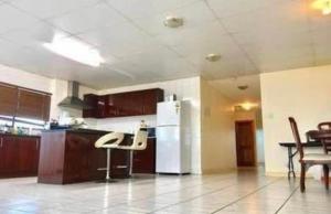 a kitchen with a white refrigerator and a table at Less pay for master room in Rosewater +18 photos