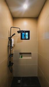 a bathroom with a shower with a window at Puy-An, A Nomad Hostel in Moalboal +64 photos