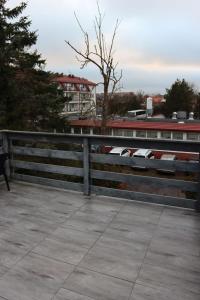 a fence with seats on top of a building at Minuta do plaży - Sarbinowo in Sarbinowo