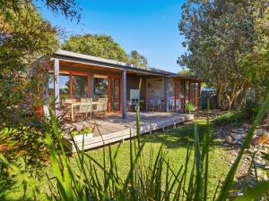 a home with a wooden deck in the yard at Prom Coast Oasis - Sandy Point in Sandy Point