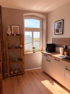 a kitchen with a sink and a window at HofQuartier Altmersleben in Altmersleben