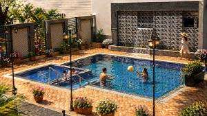 a group of people playing in a swimming pool at The Grand Maan Palace and Resort- Near Vaishali Nagar I New Building in Jaipur
